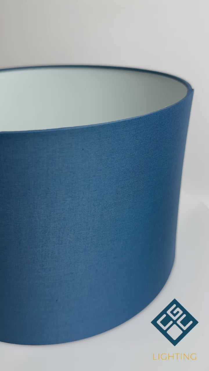 Load video: The Lucia is a modern cylinder drum shaped lamp shade in a luxury cotton finish and opal diffuser. This fantastic shade can double up as either a ceiling pendant light shade or table lampshade. Easily fits to your standard ceiling light socket - no wiring required.