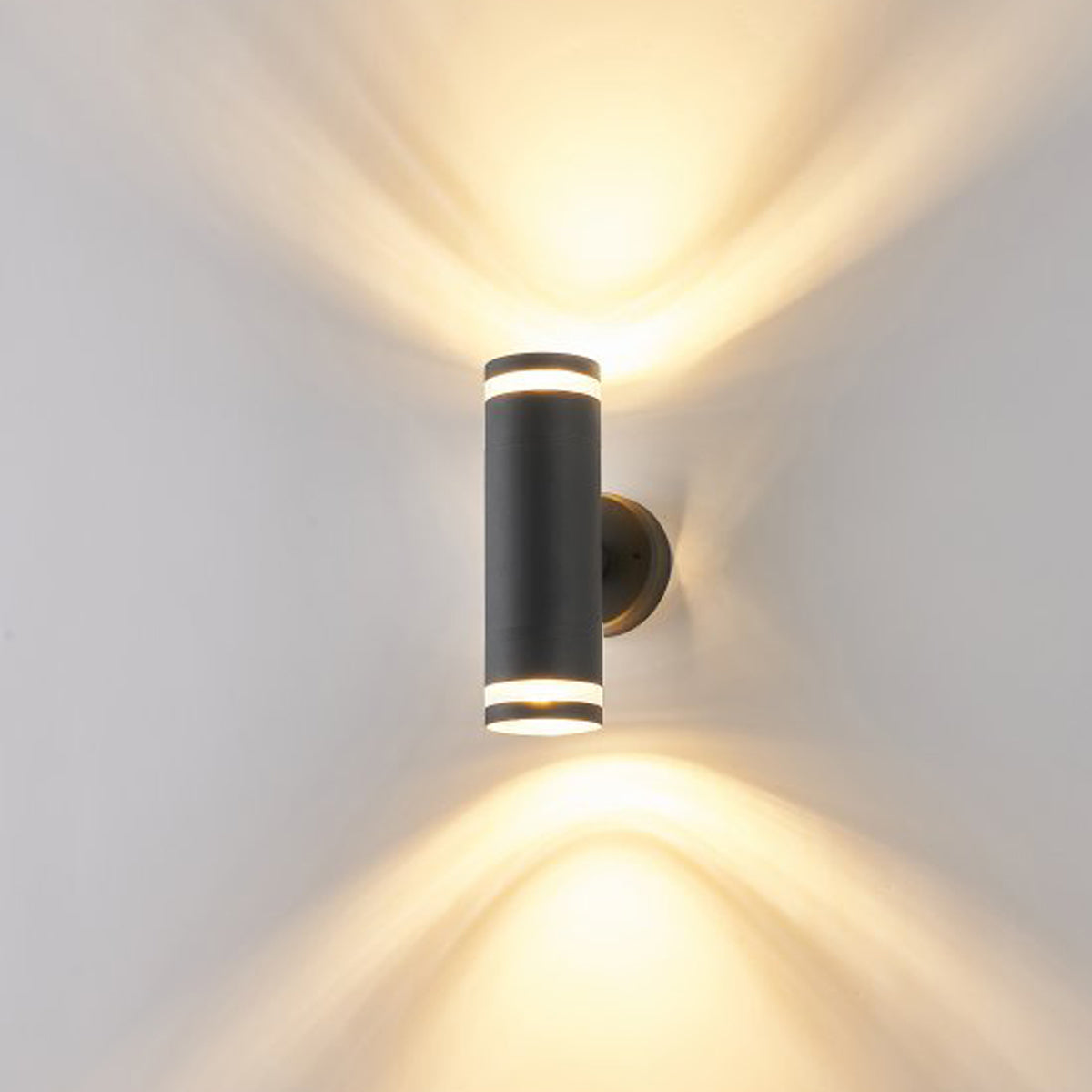 Our Jennifer dark grey outdoor wall mounted up and down cylinder outdoor light would look perfect in a modern or more traditional home design. Outside wall lights can provide atmospheric light in your garden, at the front door or on the terrace as well as a great security solution. It is designed for durability and longevity with its robust material producing a fully weatherproof and water resistant light fitting