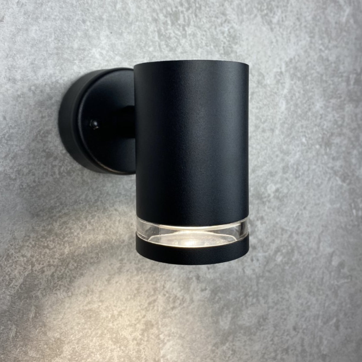 Our Jennifer black outdoor wall mounted cylinder outdoor light would look perfect in a modern or more traditional home design. Outside wall lights can provide atmospheric light in your garden, at the front door or on the terrace as well as a great security solution. It is designed for durability and longevity with its robust material producing a fully weatherproof and water resistant light fitting.