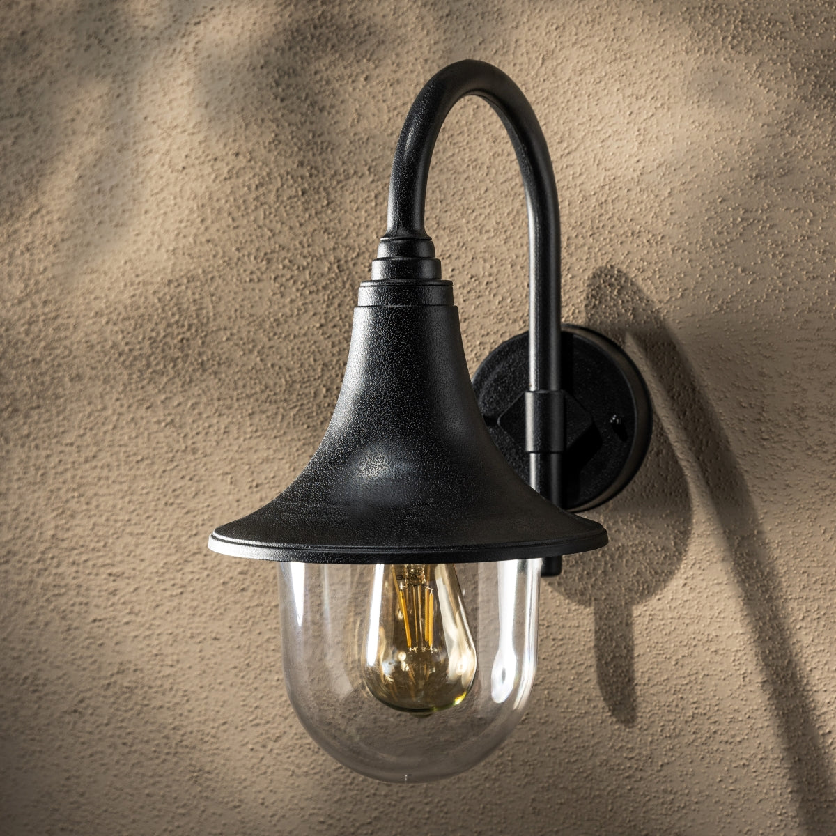 The Dinah black traditional hooked outdoor wall lantern light is constructed of polycarbonate and features an attractive design inspired by traditional lighting styles. This lantern wall light is a great choice for illuminating doorways and porches, creating a warm and inviting look and a safe environment. With an IP44 safety rating, the Dinah garden wall light is suitable for mounting on outdoor walls. Use with LED bulbs enjoy outdoor to enjoy your lighting without raising your energy bills. 