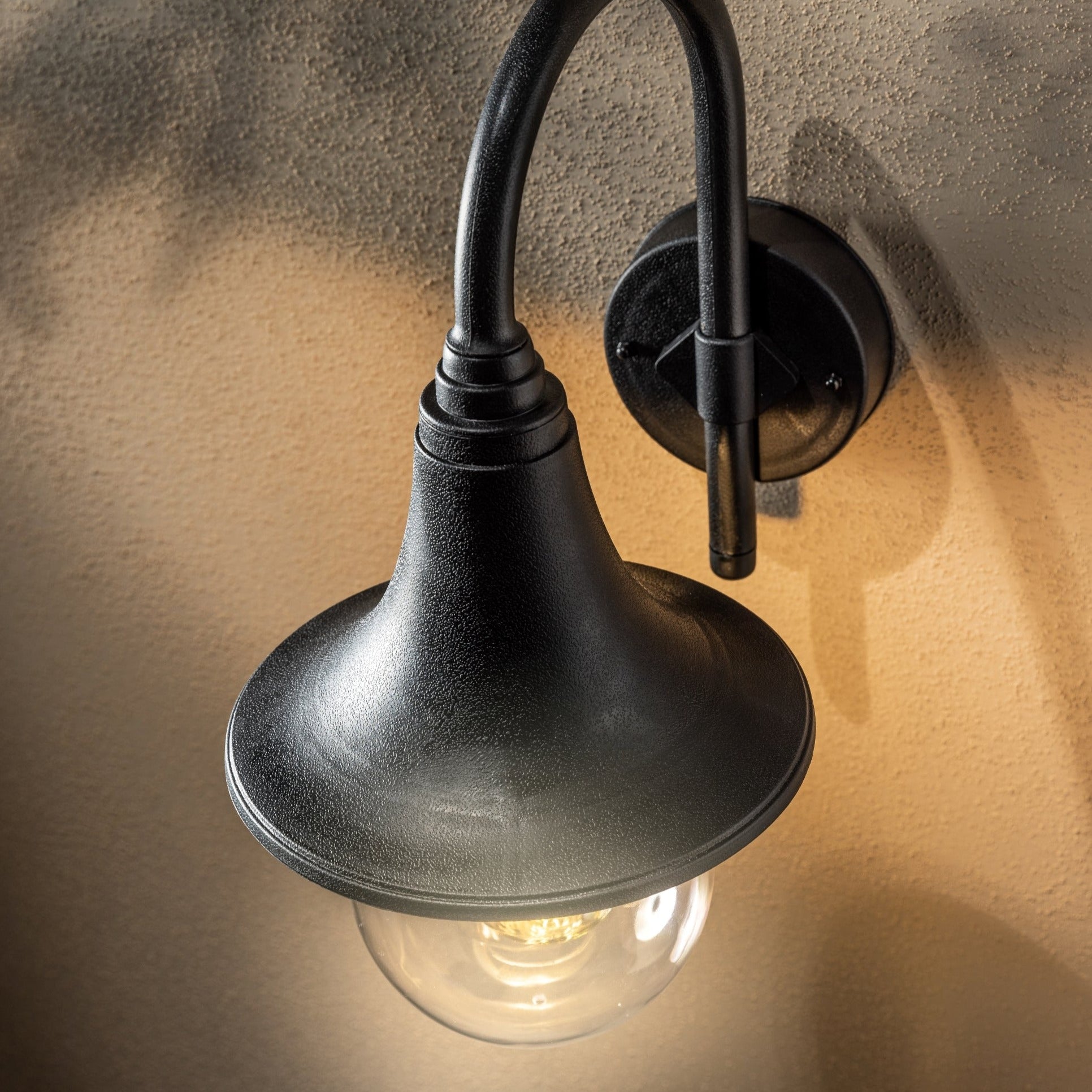 The Dinah black traditional hooked outdoor wall lantern light is constructed of polycarbonate and features an attractive design inspired by traditional lighting styles. This lantern wall light is a great choice for illuminating doorways and porches, creating a warm and inviting look and a safe environment. With an IP44 safety rating, the Dinah garden wall light is suitable for mounting on outdoor walls. Use with LED bulbs enjoy outdoor to enjoy your lighting without raising your energy bills. 