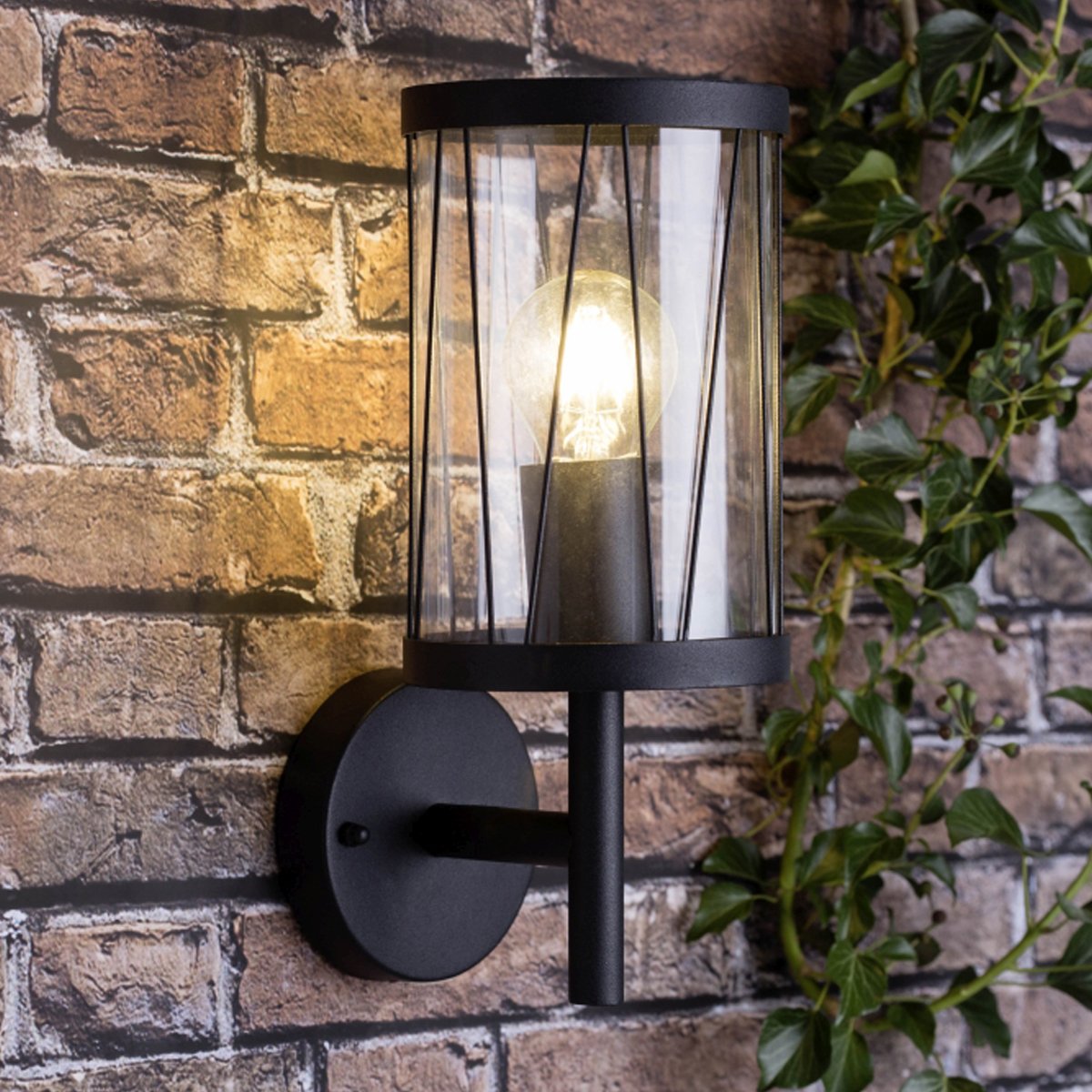 This wall light features a clear glass diffuser with a diagonal decorative pattern. It is an elegant wall light that blends well with both modern and traditional architecture. The simple, modern design of this light is suitable for outdoor areas such as front/back doors, driveways, gardens, patios, porches or garages.