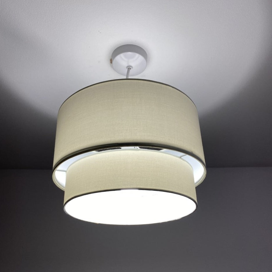 Our Kimber easy fit two tiered luxury fabric double layered shade is contemporary in its appearance and we have designed the shade to suit a range of interiors. Easy to fit simply attached to an existing pendant flitting.  It is crafted from high quality fabric material in two layers and complimented with a white inner.  INSTALLATION: Simply attach to your existing light fitting for an instant glow up