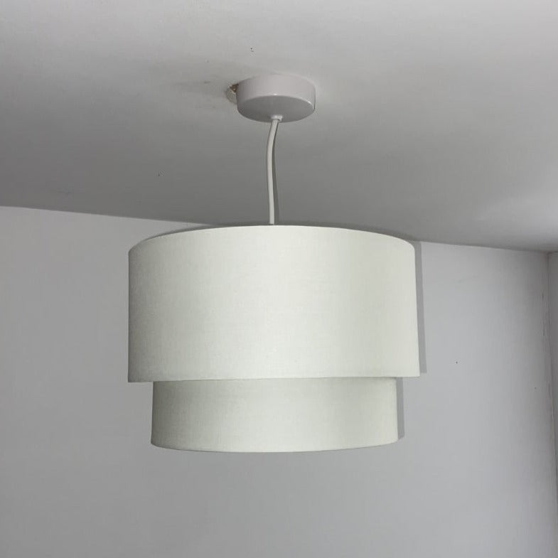 Our Kimber easy fit two tiered luxury fabric double layered shade is contemporary in its appearance and we have designed the shade to suit a range of interiors. Easy to fit simply attached to an existing pendant flitting.  It is crafted from high quality fabric material in two layers and complimented with a white inner.  INSTALLATION: Simply attach to your existing light fitting for an instant glow up