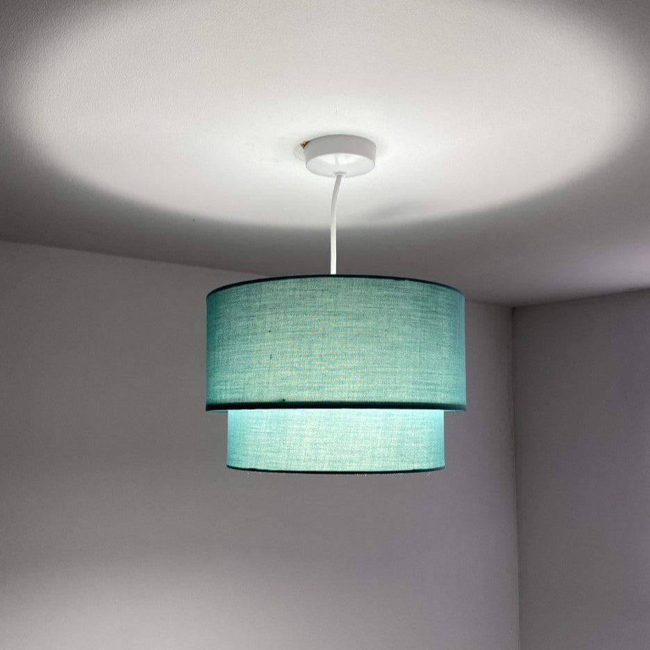 Our Kimber easy fit two tiered luxury fabric double layered shade is contemporary in its appearance and we have designed the shade to suit a range of interiors. Easy to fit simply attached to an existing pendant flitting.  It is crafted from high quality fabric material in two layers and complimented with a white inner.  INSTALLATION: Simply attach to your existing light fitting for an instant glow up
