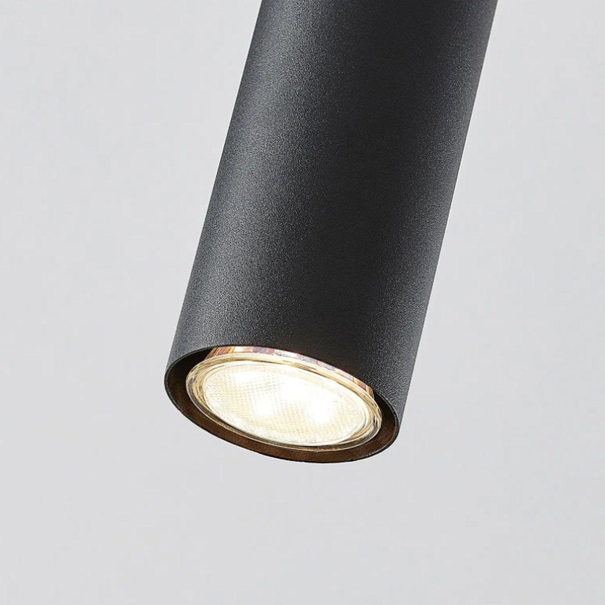 High-quality black ceiling triple hanging spotlight pendant. A cylinder pendant with a modern and sleek design would add a huge element of style and class to any room. Made of aluminium with a powder coat finish. Height can be adjusted during installation.