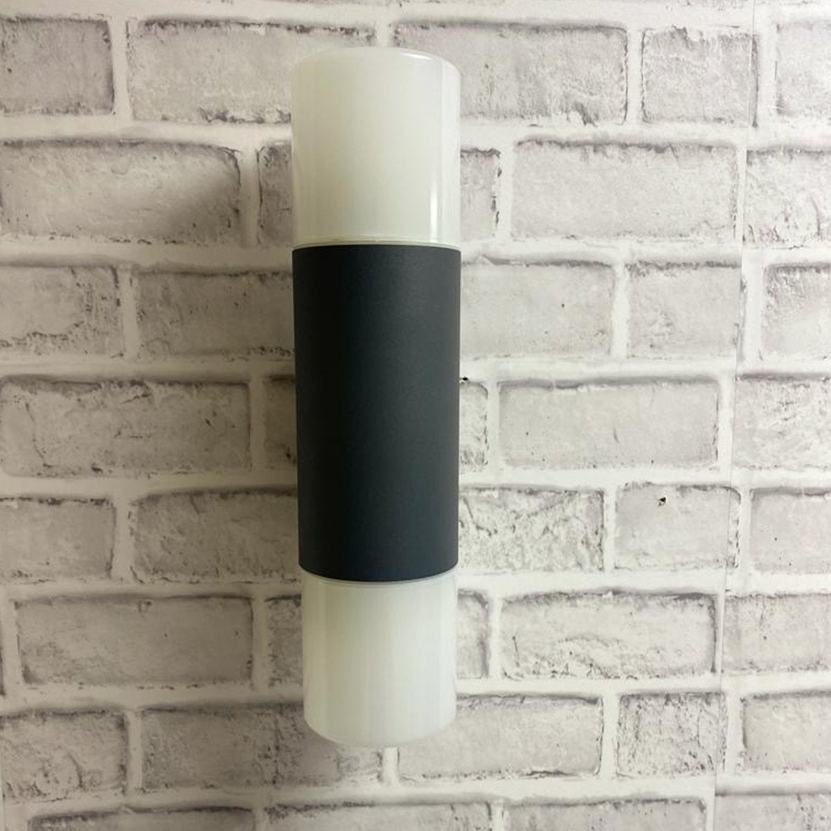 Our Cortez wall light looks great in modern settings. This wall light has a modern tube design with anthracite finish aluminium body and 2 polycarbonate opal diffusers. This wall light is perfect for any outdoor space requiring light and security such as gardens, driveways, doorways workspaces, pubs and hotels.