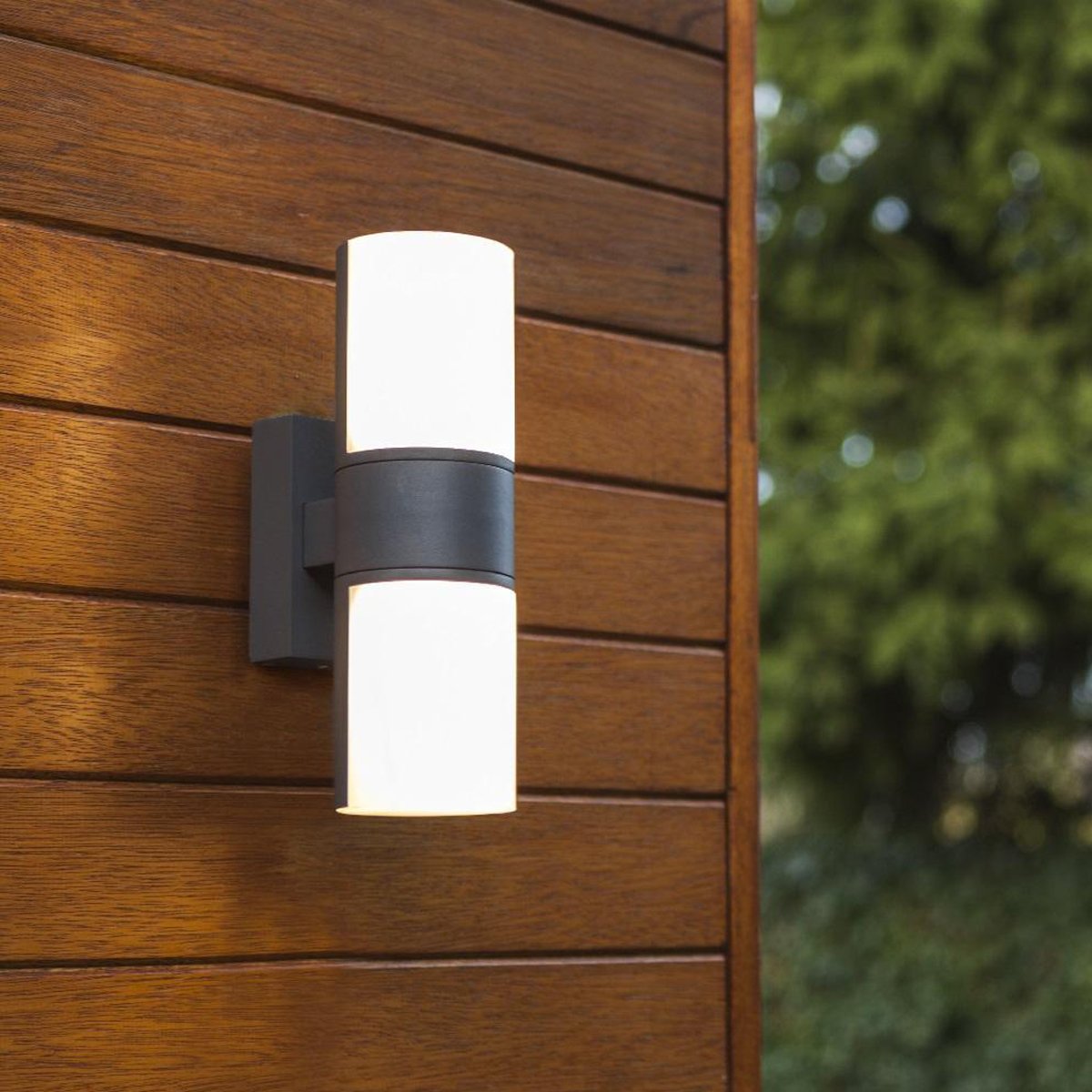 Our Faith dark grey anthracite outdoor wall mounted cylinder light would look perfect in a modern or more traditional home design. Outside wall lights can provide atmospheric light in your garden, at the front door or on the terrace as well as a great security solution. It is designed for durability and longevity with its robust material producing a fully weatherproof and water resistant light fitting.