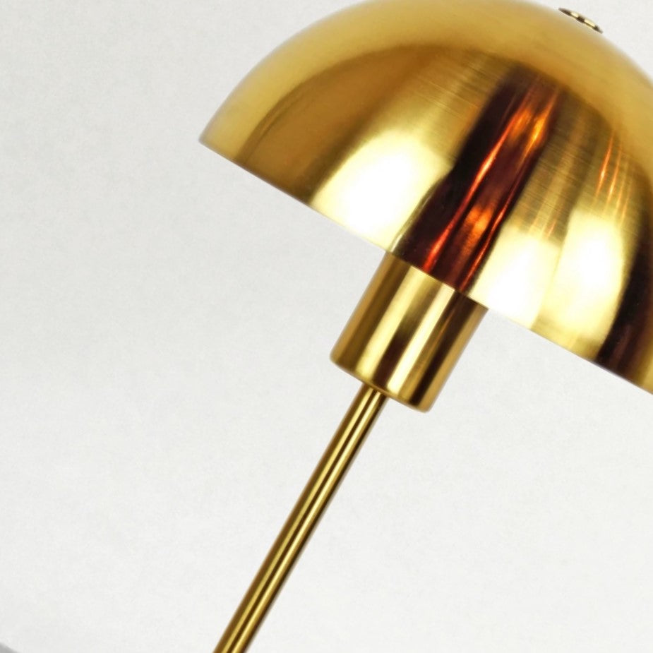 Our Kelly table lamp is a strong visual addition to your space with its distinctive dome-shaped shade and metal frame. Thanks to its brushed gold brass metal finish, it will suit both modern and Mid-Century inspired settings. Light reflects off the shade to enhance a warm and inviting glow.