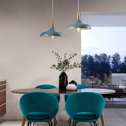 Two of the Esther Pendants  placed over a table. The Esther pendant is a stylish modern metal ceiling light finished in Marine blue with a white inner.  Complete with a gold and wooden cap detail attached to a white adjustable cable and m