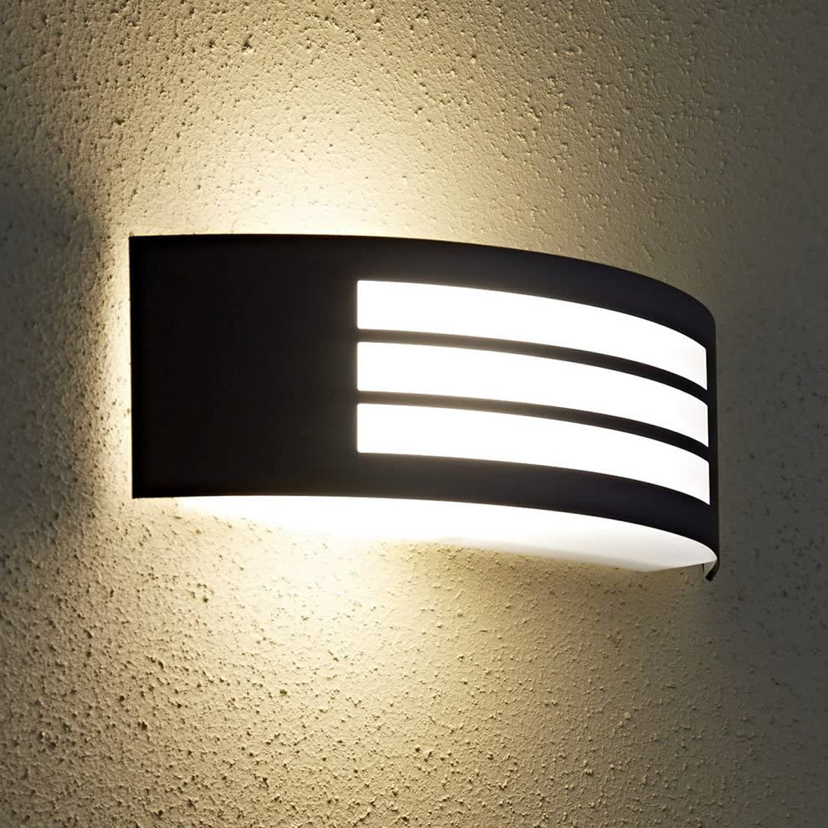 This stylish Striker outdoor light boasts a polycarbonate shade, crafted from stainless steel and adorned with a series of narrow stripes. Its surface disperses the lamp's light uniformly, creating a tranquil, inviting ambiance both indoors and out.