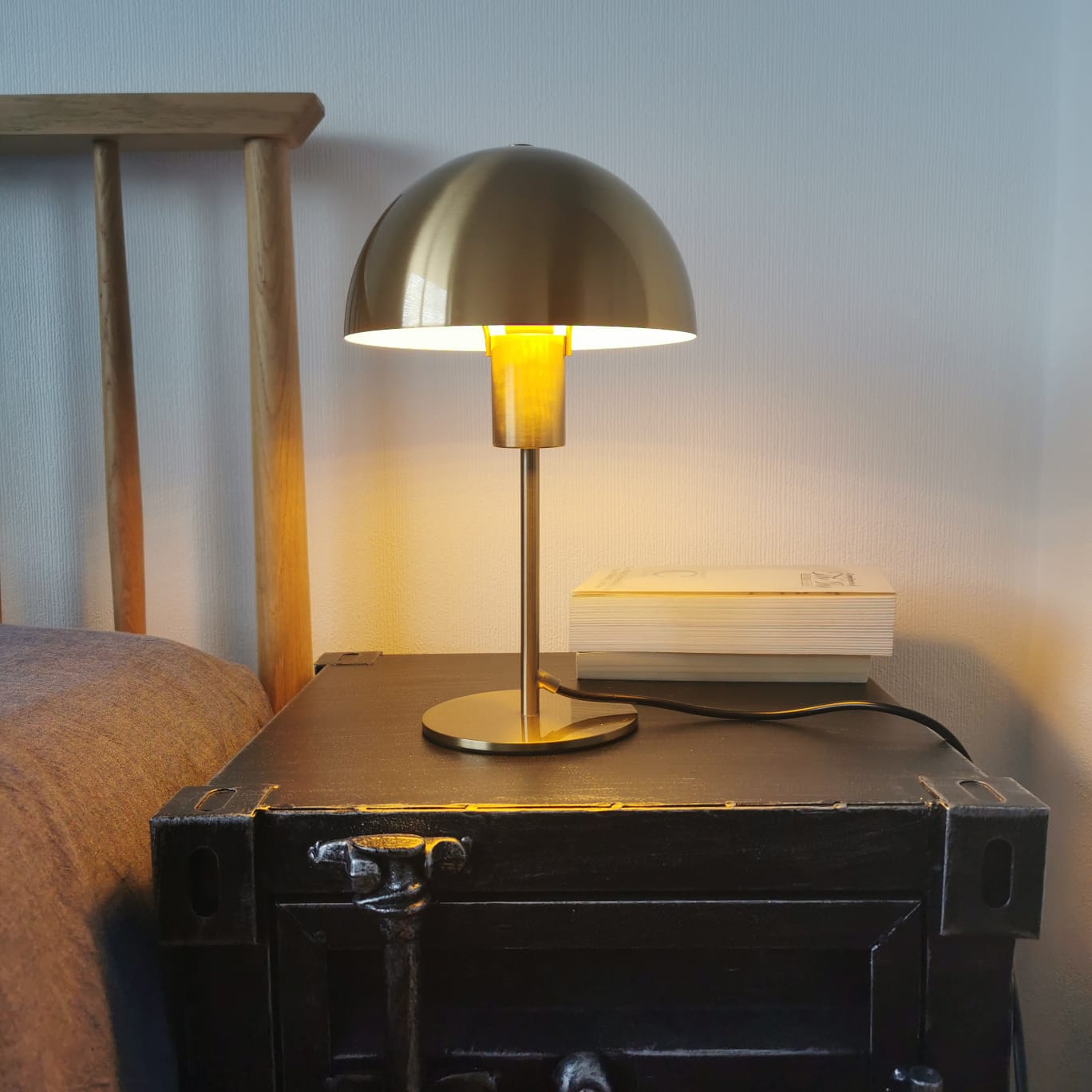 Our Kelly table lamp is a strong visual addition to your space with its distinctive dome-shaped shade and metal frame. Thanks to its brushed gold brass metal finish, it will suit both modern and Mid-Century inspired settings. Light reflects off the shade to enhance a warm and inviting glow.