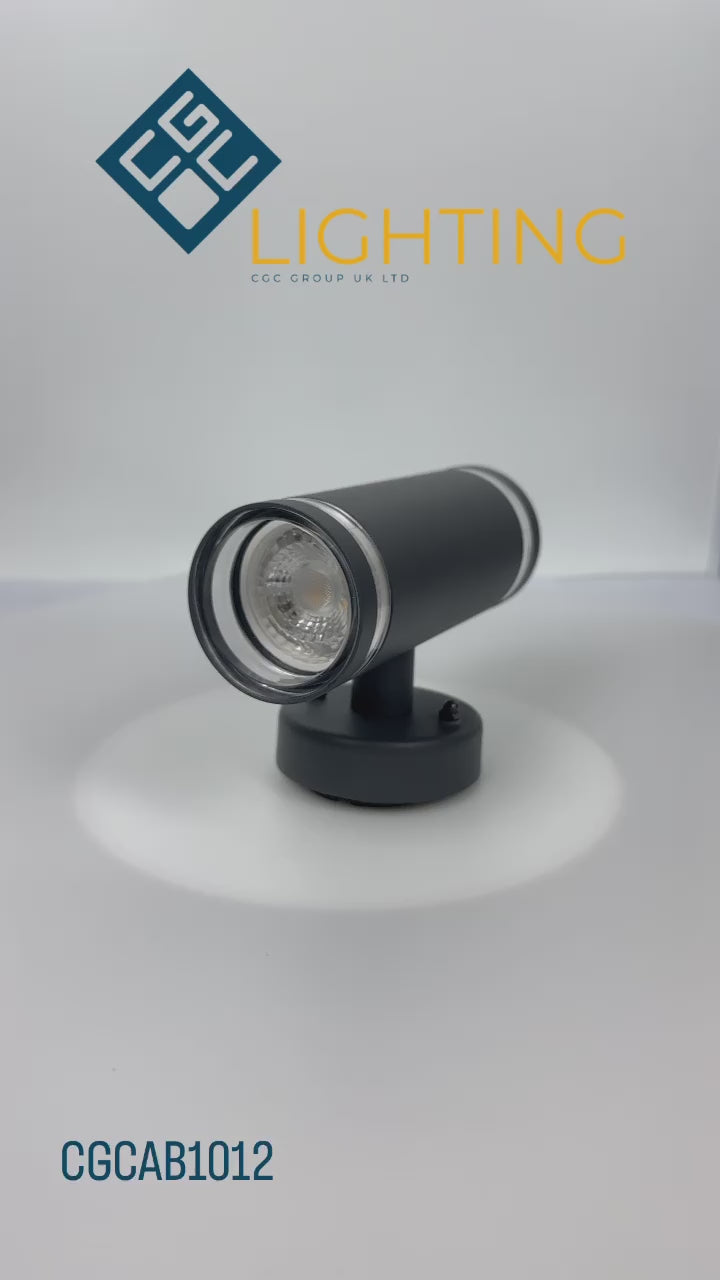 Load video: Our Jennifer dark grey outdoor wall mounted up and down cylinder outdoor light would look perfect in a modern or more traditional home design. Outside wall lights can provide atmospheric light in your garden, at the front door or on the terrace as well as a great security solution. It is designed for durability and longevity with its robust material producing a fully weatherproof and water resistant light fitting